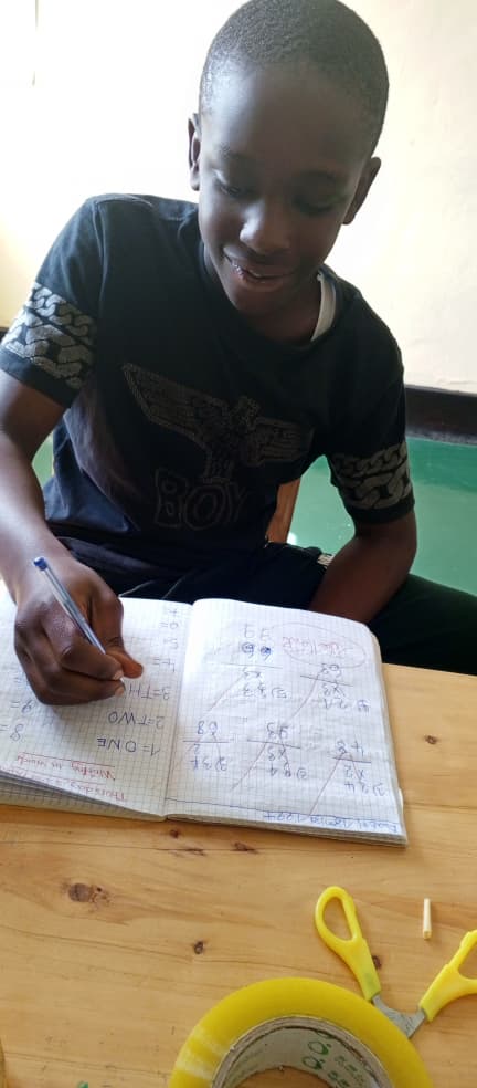 Child working on fine motor skills with educational materials